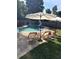 A spacious backyard featuring a pool, lounge chairs, and shade umbrellas for an ideal outdoor living experience at 180 Spring Ridge Trace, Roswell, GA 30076