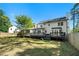 Large backyard with a deck, screened-in porch, and lush green grass at 180 Spring Ridge Trace, Roswell, GA 30076