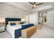 Primary bedroom showcases a large bed, carpet floors, tray ceilings, and ample closet space at 180 Spring Ridge Trace, Roswell, GA 30076