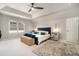 Spacious bedroom with tray ceilings, carpet floors, a large window and a blue upholstered bed at 180 Spring Ridge Trace, Roswell, GA 30076