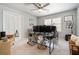 Bright bedroom with ample sunlight, a ceiling fan and an unorganized desk with multiple monitors at 180 Spring Ridge Trace, Roswell, GA 30076