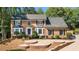 Traditional brick home featuring manicured landscaping and a curved driveway at 180 Spring Ridge Trace, Roswell, GA 30076