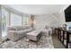 Cozy living room featuring stylish furniture, modern decor, and ample natural light at 180 Spring Ridge Trace, Roswell, GA 30076