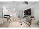 A modern living room with a cozy sectional sofa, mirrored dresser, and flat-screen television at 180 Spring Ridge Trace, Roswell, GA 30076