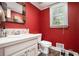 Cozy powder room with a modern vanity and decorative mirror at 180 Spring Ridge Trace, Roswell, GA 30076