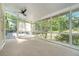 Sunroom with large windows, a ceiling fan, and access to the deck and backyard at 180 Spring Ridge Trace, Roswell, GA 30076