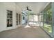 A bright sunroom with white walls and large windows offering views of the surrounding greenery at 180 Spring Ridge Trace, Roswell, GA 30076