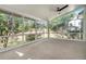 Bright sunroom with a ceiling fan and a wall of windows overlooking a lush backyard at 180 Spring Ridge Trace, Roswell, GA 30076