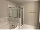 Beautiful bathroom with a soaking tub, glass shower, and marble-look tile surround at 2458 Morgan Creek Rd, Buford, GA 30519