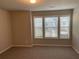 Cozy bedroom featuring neutral walls, carpeted floors, and a window with natural light at 2458 Morgan Creek Rd, Buford, GA 30519