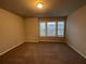 Carpeted bedroom featuring a window letting in natural light at 2458 Morgan Creek Rd, Buford, GA 30519