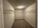 Walk-in closet is fitted with wire shelving and carpeted floor at 2458 Morgan Creek Rd, Buford, GA 30519