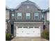 Charming brick townhouse with a two-car garage and decorative shutters at 2458 Morgan Creek Rd, Buford, GA 30519