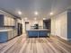 Spacious kitchen showcasing an island, gray cabinets, stainless steel appliances, and hardwood floors at 2458 Morgan Creek Rd, Buford, GA 30519