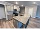 Modern kitchen features gray cabinets, stainless steel appliances, and a large center island at 2458 Morgan Creek Rd, Buford, GA 30519