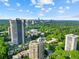 High-rise condominiums offering breathtaking cityscape and green space views, with a bright, sunny sky overhead at 2626 Peachtree Nw Rd # 606, Atlanta, GA 30305