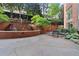 Tranquil courtyard with a tiered fountain, lush landscaping, and a table and chairs for outdoor seating at 2626 Peachtree Nw Rd # 606, Atlanta, GA 30305
