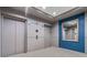 Hallway view of condo elevators with modern doors and decor at 2626 Peachtree Nw Rd # 606, Atlanta, GA 30305