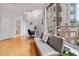 Bright living room featuring hardwood floors, neutral tones, a modern desk, and large windows at 2626 Peachtree Nw Rd # 606, Atlanta, GA 30305