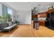 Open living room featuring hardwood floors, large windows and a modern kitchen with stainless steel appliances at 2626 Peachtree Nw Rd # 606, Atlanta, GA 30305