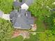 Aerial view of a home showcasing a large lot, stone patio and lush landscaping at 2773 Brookgrove Se Ln, Atlanta, GA 30339