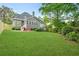 Spacious backyard with well-maintained lawn, stone patio, and gray siding house at 2773 Brookgrove Se Ln, Atlanta, GA 30339
