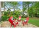 Backyard stone patio featuring outdoor seating, lush lawn and mature shade trees at 2773 Brookgrove Se Ln, Atlanta, GA 30339