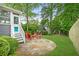 Beautifully landscaped backyard with a stone patio and red Adirondack chairs at 2773 Brookgrove Se Ln, Atlanta, GA 30339