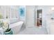 Relaxing bathroom showcasing a standalone tub beneath window and white marble flooring at 2773 Brookgrove Se Ln, Atlanta, GA 30339