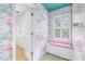 Stylish bathroom showcasing flamingo wallpaper, shuttered windows, and a built-in seat with pink cushion at 2773 Brookgrove Se Ln, Atlanta, GA 30339