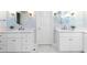 Bright bathroom featuring dual vanities with white cabinets and marble countertops and flooring at 2773 Brookgrove Se Ln, Atlanta, GA 30339