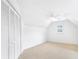 A clean and empty bedroom featuring a ceiling fan and closet with shutter doors at 2773 Brookgrove Se Ln, Atlanta, GA 30339