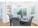 Charming dining area with hardwood floors, built-in shelves, and four gray upholstered chairs at 2773 Brookgrove Se Ln, Atlanta, GA 30339