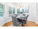 Bright dining area featuring a modern chandelier, stylish gray chairs, and hardwood floors at 2773 Brookgrove Se Ln, Atlanta, GA 30339