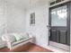 Cozy front porch featuring a swing and textured stone wall detail at 2773 Brookgrove Se Ln, Atlanta, GA 30339
