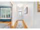 Hallway with wood flooring, white trim, and a view into a room with blue accents at 2773 Brookgrove Se Ln, Atlanta, GA 30339