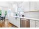 Bright kitchen featuring stainless steel appliances, white cabinetry, and hardwood flooring at 2773 Brookgrove Se Ln, Atlanta, GA 30339
