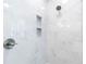 Modern shower featuring white marble-style tile, and two recessed shower shelves at 2773 Brookgrove Se Ln, Atlanta, GA 30339