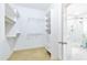 A well-organized walk-in closet leading to a bright bathroom with a glass shower at 2773 Brookgrove Se Ln, Atlanta, GA 30339