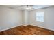 Cozy bedroom with hardwood floors, a ceiling fan, natural light from the window, and neutral paint at 2796 Green Trail Dr, Atlanta, GA 30349