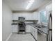 Modern kitchen features stainless steel appliances, granite countertops, white cabinets, and tiled floors at 2796 Green Trail Dr, Atlanta, GA 30349
