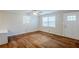 Spacious living room featuring hardwood floors, a ceiling fan, and large windows for natural light at 2796 Green Trail Dr, Atlanta, GA 30349