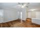 Open living room with hardwood floors, ceiling fan, a column partition, and neutral paint throughout at 2796 Green Trail Dr, Atlanta, GA 30349