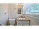 Bathroom featuring granite vanity, modern fixtures, and a window for natural light at 3497 Glensford Dr, Decatur, GA 30032