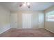 Spacious bedroom featuring a ceiling fan, carpet flooring, and multiple closets at 3497 Glensford Dr, Decatur, GA 30032