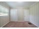 Bedroom featuring natural lighting, carpet floors, and a large double door closet at 3497 Glensford Dr, Decatur, GA 30032