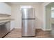 Kitchen view showing a stainless steel refrigerator with granite countertops and wood-look flooring at 3497 Glensford Dr, Decatur, GA 30032