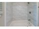 This shower features white tile and a chrome shower head at 3497 Glensford Dr, Decatur, GA 30032