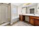 Bright bathroom featuring double vanity, soaking tub, and glass-enclosed shower at 1452 Evanston Ln, Marietta, GA 30062