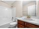 Bathroom features wood vanity, white sink, toilet, shower and tub combination, and a large mirror at 1452 Evanston Ln, Marietta, GA 30062